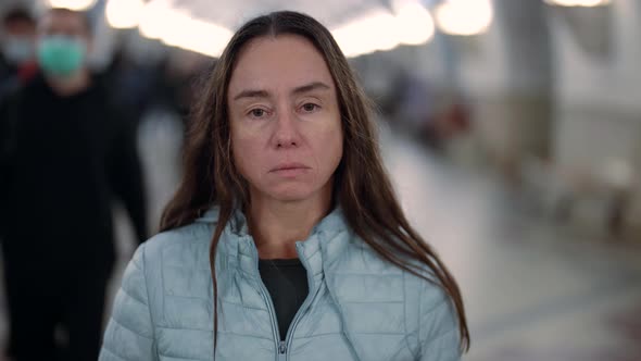 Sad and Tired Townswoman in Pedestrian Subway Looking at Camera alt