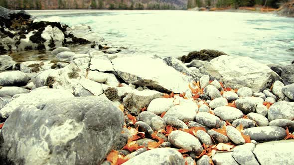 Dolly Slider Shot of the Splashing Water in a Mountain River Near Forest. Wet Rocks and Sun Rays alt