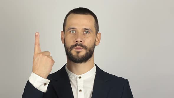 Young Handsome Businessman Is Showing One Finger While Counting