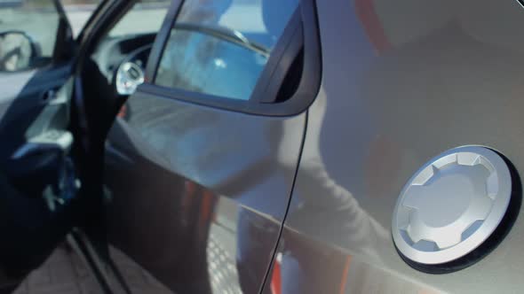 Man Refueling Car alt