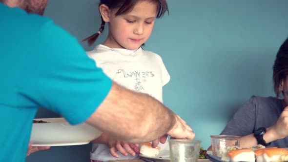 Family eating dinner together alt