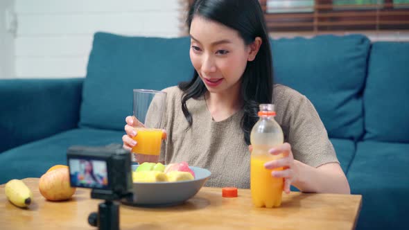 Asian women using camera streaming and recording vlog video about the benefit for broadcast online. alt