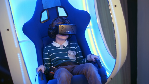 Surprised little boy experiencing virtual reality in a