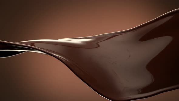 Super Slow Motion Shot of Twisting Chocolate Splash on Brown Gradient Background at 1000 Fps alt