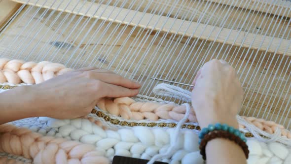 Weaving on a Loom. Woman's Hands Running on a Loom