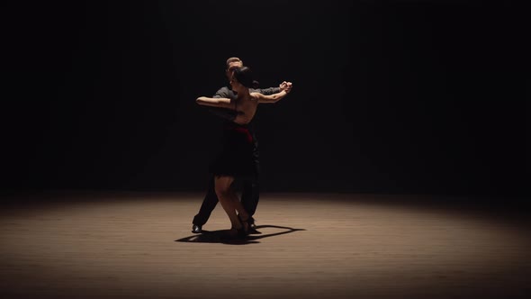 Couple Performing Emotional Dance in the Dark with Backlight alt