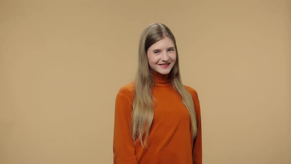 Portrait of Fashion Model Coquettishly Looking at Camera and Smiling alt