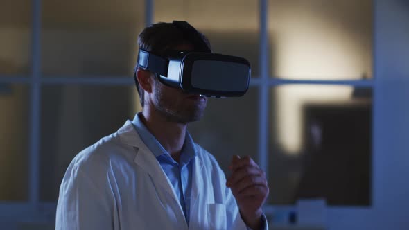 Caucasian male doctor wearing vr headset using virtual interface alt