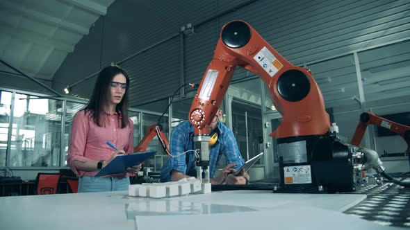 Science Students Are Monitoring a Robotic Arm Relocating Objects alt