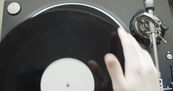 Playing vinyl record on vintage gramophone