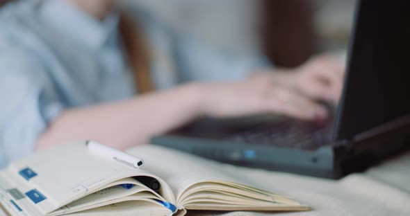 Smiling Woman Working on Laptop at Home Office. Businesswoman Typing on Computer Keyboard. alt