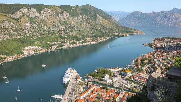 View from above to the Kotor city and cruise ship in Boka Kotor bay in the morning, 4K time lapse