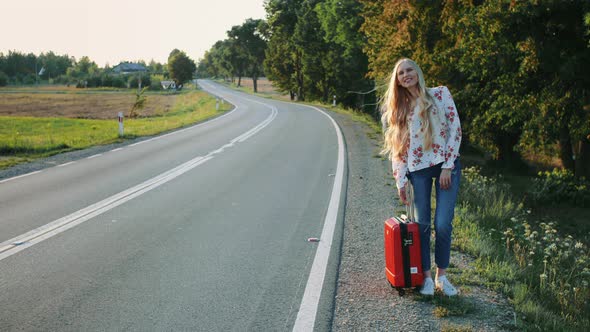 Young Lady Hitchhiking on Countryside Road alt