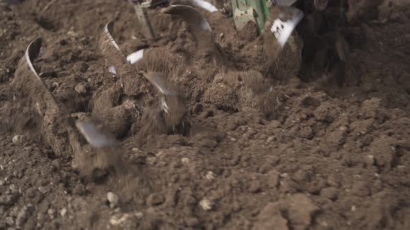 Man Plowing the Land in the Garden on Sky Background