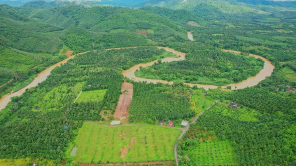 4K : Aerial view over farmland and hill farming alt