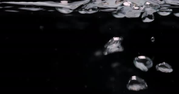 Large Air Bubbles Lift Up From Bottom To Clear Water Surface alt