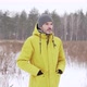 Man in a yellow jacket who stands in a snowfall on a field - VideoHive Item for Sale