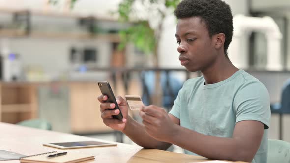 Online Shopping on Smartphone By African Man, Online Payment alt