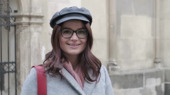 Young Woman With Dental Braces Smiling Happily. Young Beautiful Girl With Glasses Sincerely Smiling.