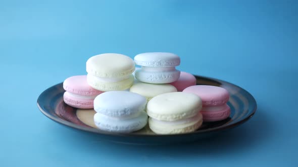Child Boy Hand Pick Colorful Macaroon in a Bowl alt
