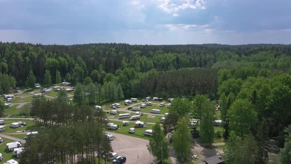 Beautiful Aerial Shot of a Caravan Park Surrounded By a Forest alt
