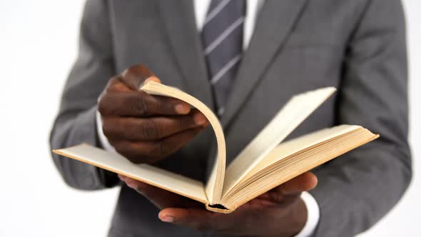 Businessman flipping pages of a book alt