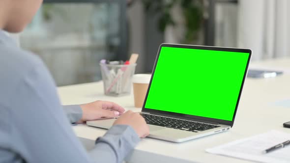 Rear View of African Woman Using Laptop with Green Chroma Key Screen alt