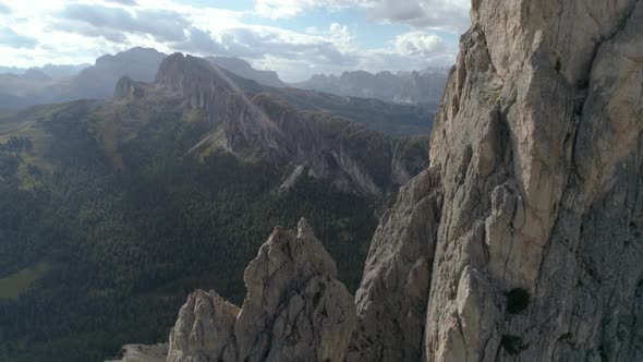 Epic Aerial Flying Close to a Mountain Peak in the Italian Dolomites Revealing more in the Backgroun alt