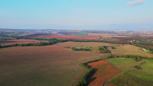 Ukrainian fields stretch on the hills near the settlements Aerial view