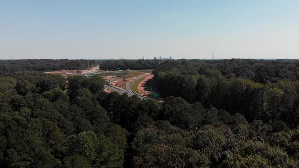 Drone shot of highway with downtown Raleigh North Carolina in distance alt