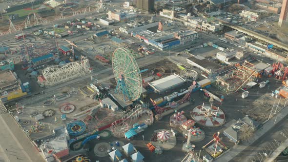 Aerial Descending Drone Shot of Coney Island Ferris Wheel and Amusement Park alt