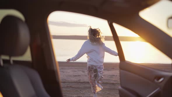 Woman Driver Running Outside the Car to the Sea alt