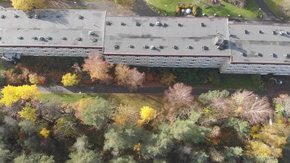Residential Building Rooftop Complex Fall Foliage Top Down Aerial Forward