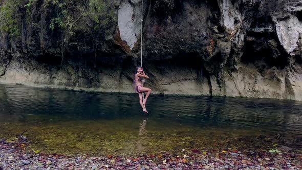 Cute Asian Girl in Bikini Playing on a Rope in the River Thailand