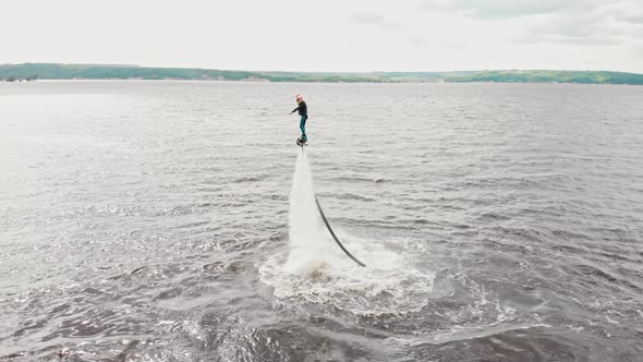 Water Sports  a Man Flying Over the Water  Aerial View alt
