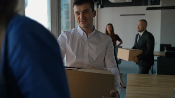 Female Boss and Group of Cheerful Office Workers While Moving Into New Office. alt