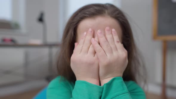 Closeup Little Person with Hands Covering Face Gesturing Smiling Looking at Camera alt