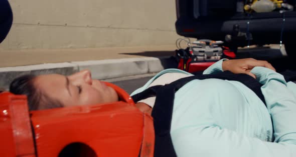 ambulance team transporting a woman alt