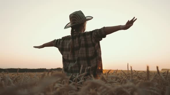 Happy Girl Child Plays Pilot on Wheat Field at Sunset alt
