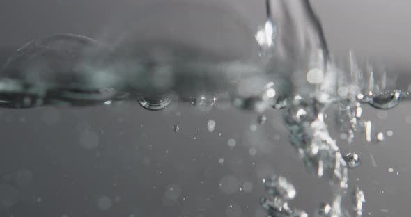 Water Surface With Bubbles Rising And Forming As Liquid Is Added alt