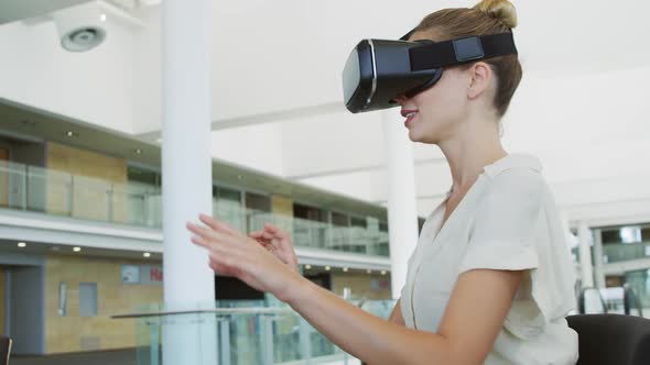 Businesswoman using VR in a modern office alt