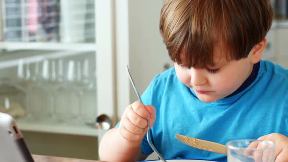 Boy having breakfast on dinning table 4k alt