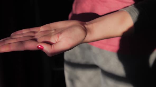 Woman washing her hands with a gel sanitizer alt