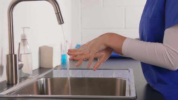 Doctor or Nurse Washing Hands with Liquid Soap alt