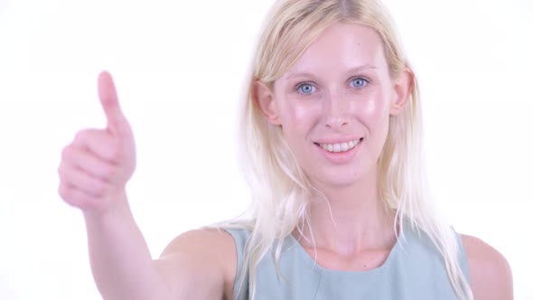 Face of Happy Young Blonde Woman Giving Thumbs Up alt