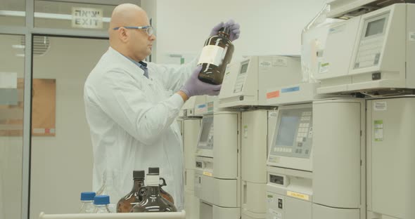 Scientist working with mass spectrometer in a pharmaceutical laboratory conducting experiments alt