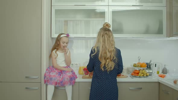 Family Preparing Breakfast Together in Kitchen alt