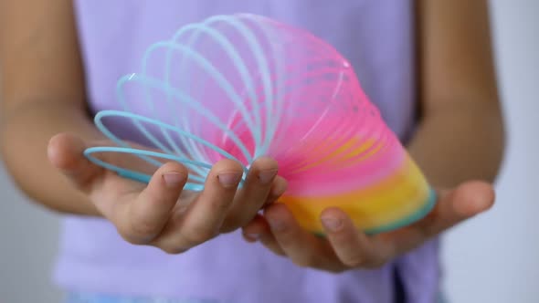 Trend Slinky rainbow toy from the '90s. A multicolored children's spiral toy. alt