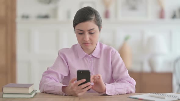 Attractive Indian Woman using Smartphone in Office alt