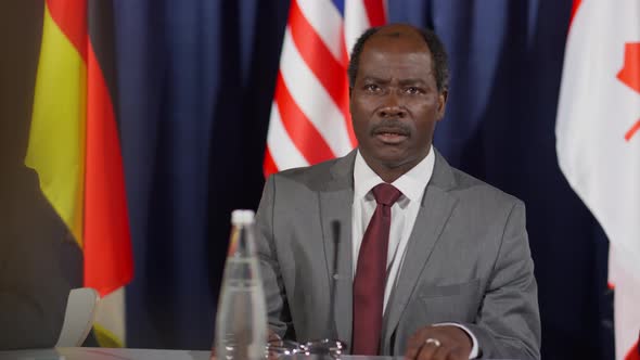 African American Leader Speaking with Journalist at Press Conference alt